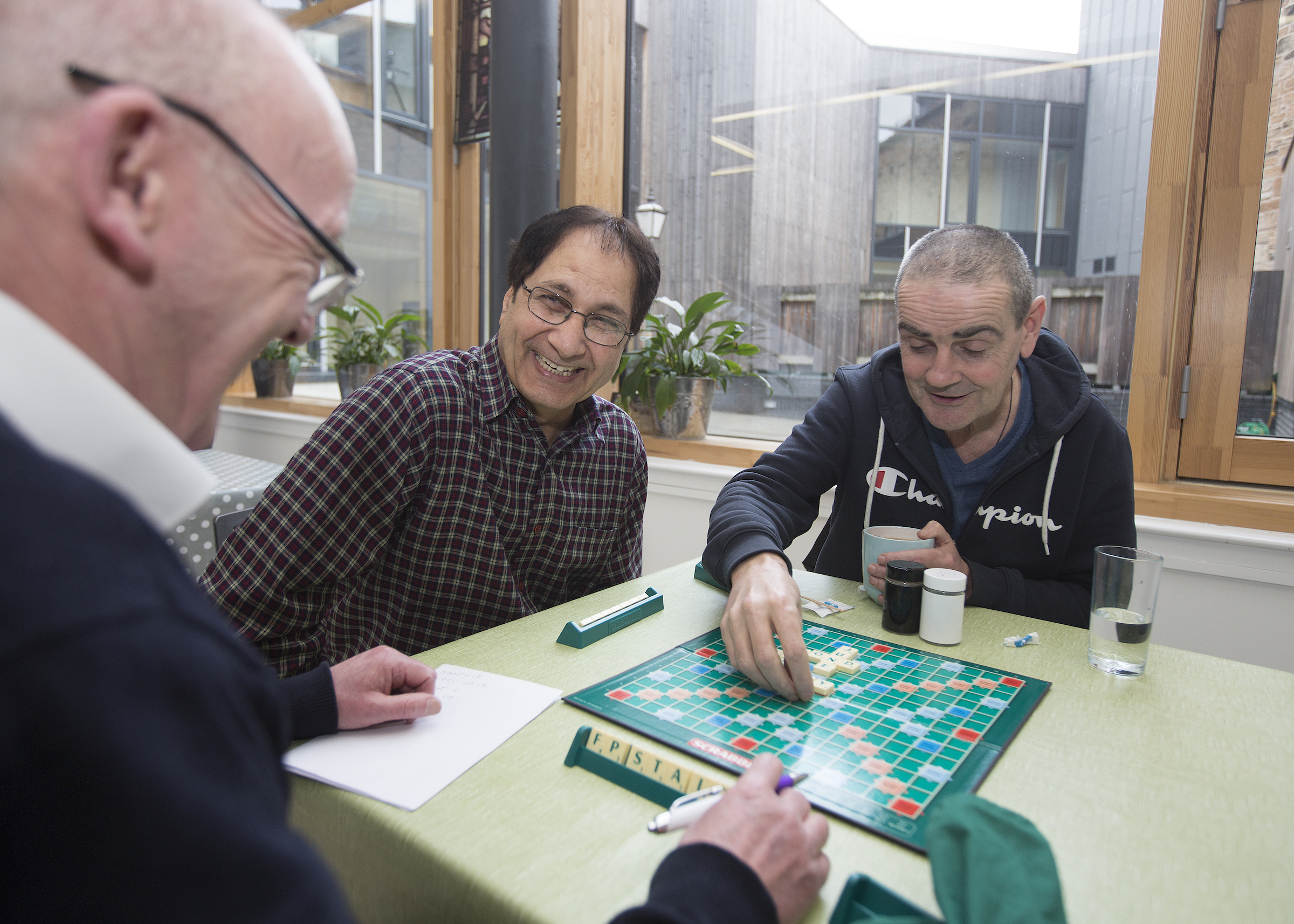 Drink Wise, Age Well staff and clients play a game of Scrabble